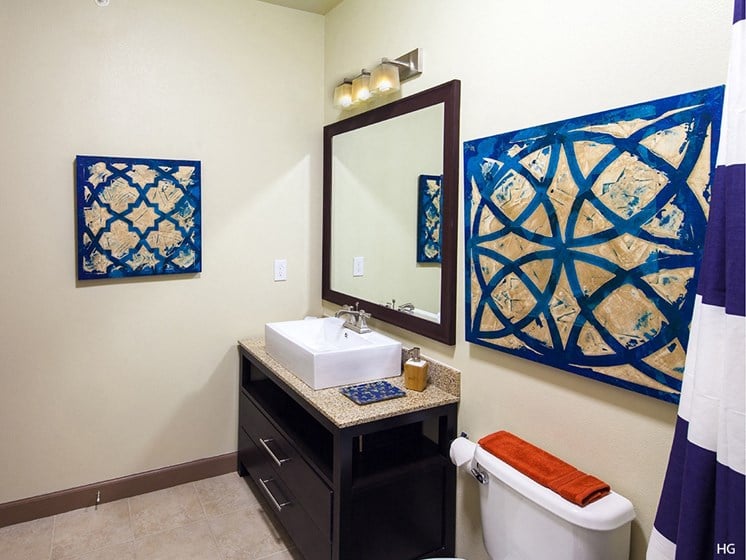 a bathroom with a white sink and blue tiles on the walls